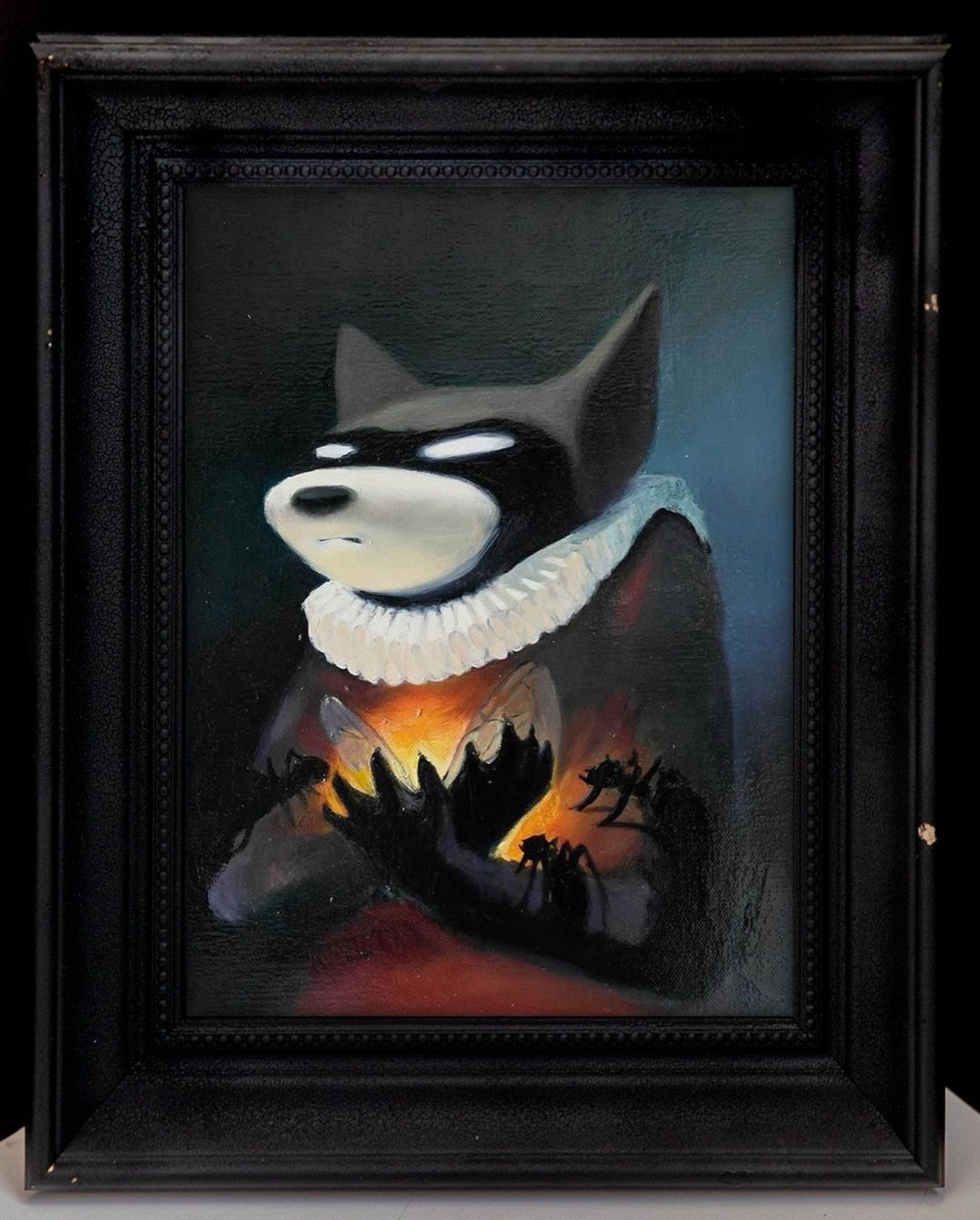 Dark portrait with a fire burning inside an open coat