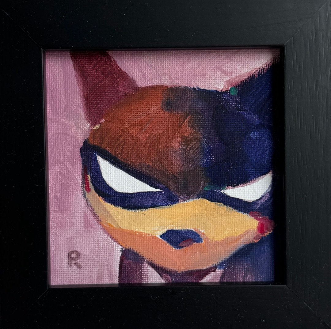 Masked fox face in navy and rust with narrowed white eyes, on pink, in a black frame