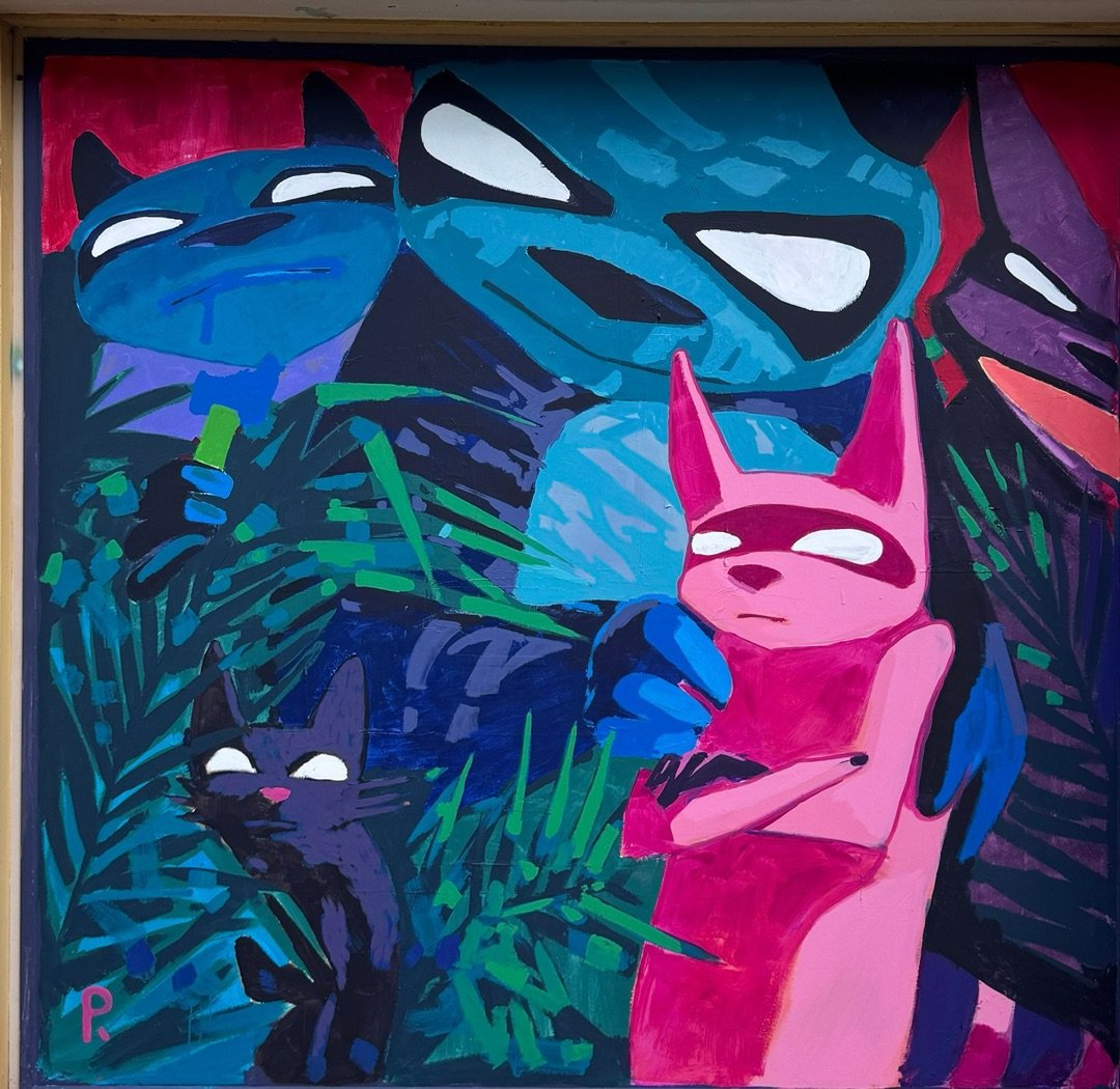 Pink creature with folded arms and a small black cat among jungle leaves, with three big masked blue and purple faces behind them