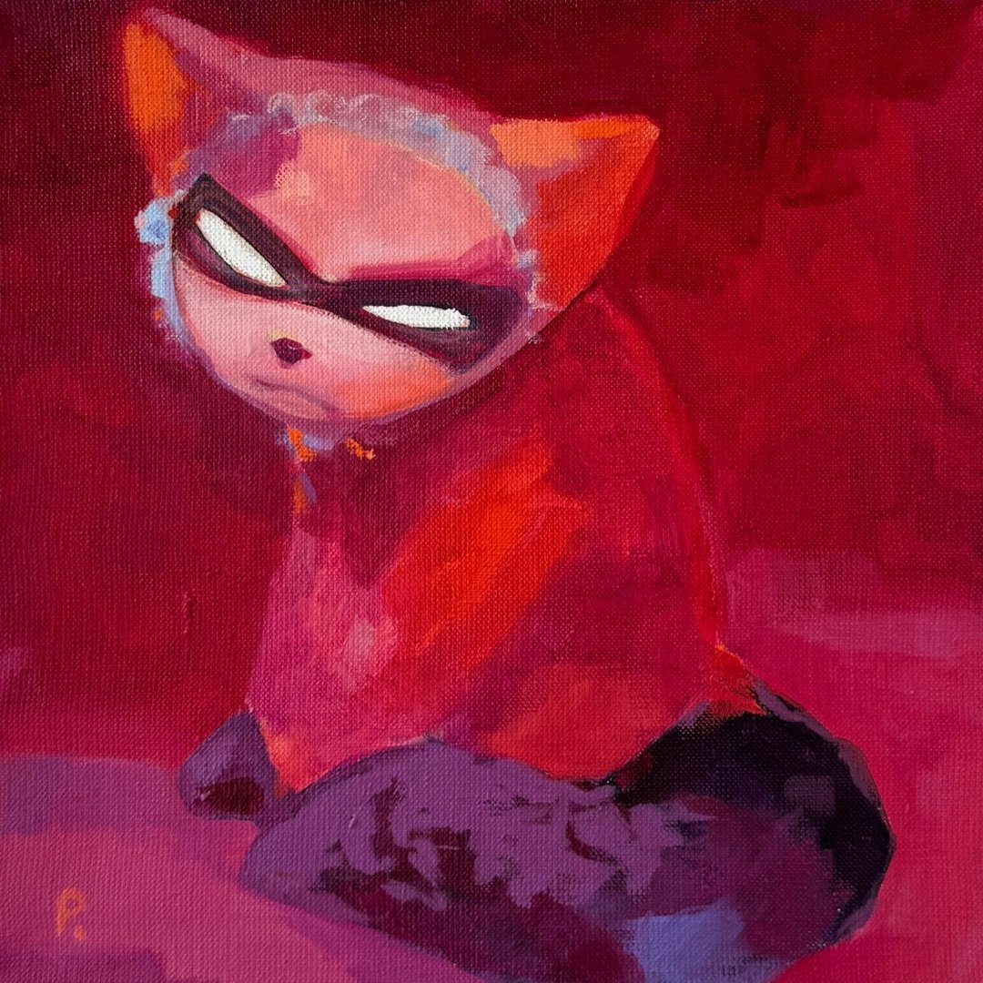 Red cat in a mask and lace bonnet sitting on a crimson ground